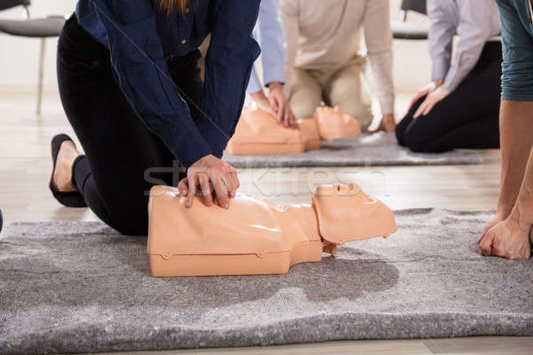 Students Practicing CPR Chest Compression On Dummy Stock photo © AndreyPopov