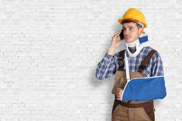 Handyman With Fractured Hand Calling On Mobile Phone Stock photo © AndreyPopov