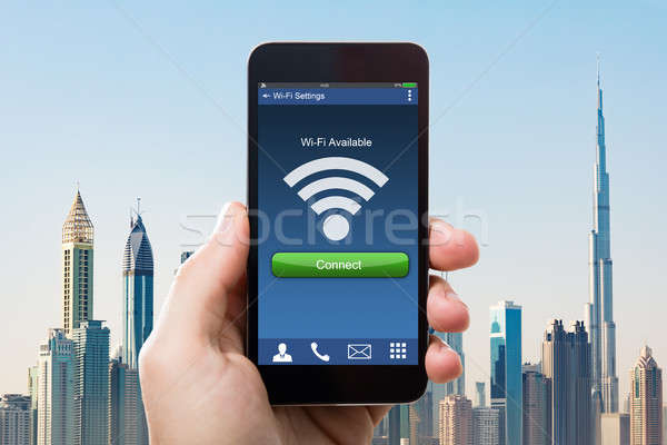 Hand Holding Smart Phone With Wi-fi Availability On Screen Stock photo © AndreyPopov