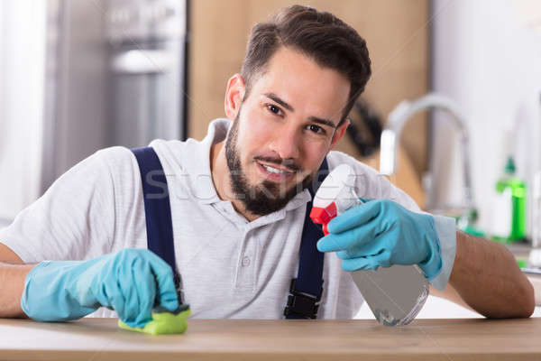Man Cleaning Kitchen Worktop Stock photo © AndreyPopov