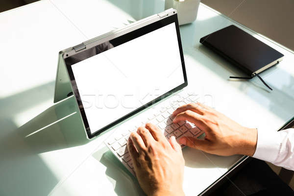 бизнесмен рабочих ноутбука белый экране Сток-фото © AndreyPopov