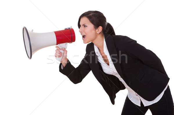 Woman shouts through a megaphone Stock photo © AndreyPopov