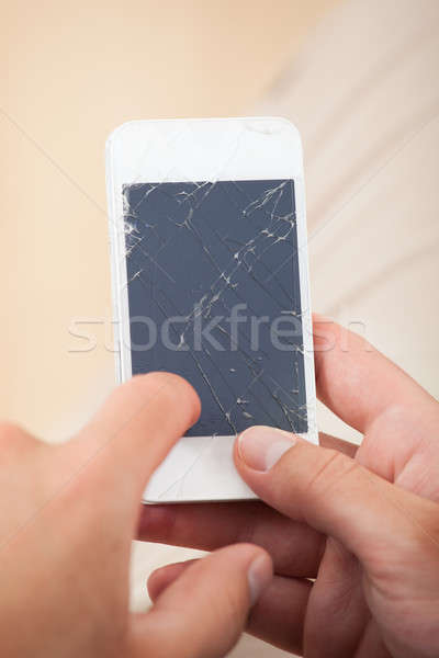 Hand Holding Smartphone With Broken Screen Stock photo © AndreyPopov