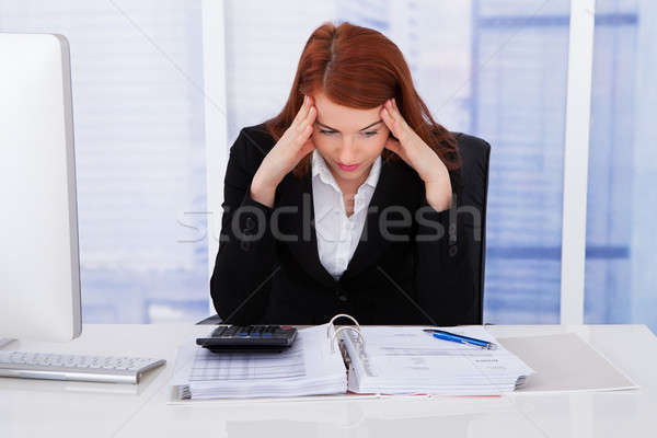 Tensed Businesswoman At Office Desk Stock photo © AndreyPopov