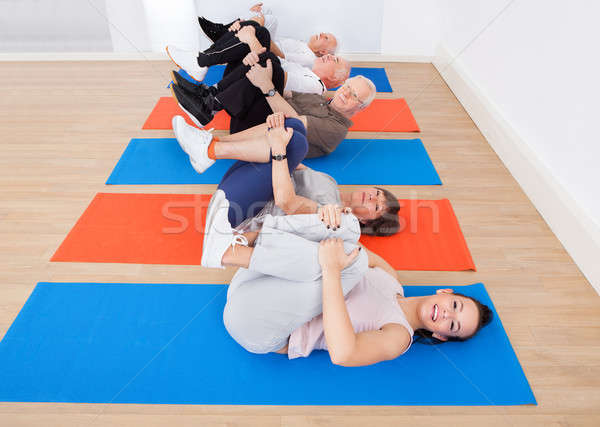 People Exercising On Mats At Gym Stock photo © AndreyPopov