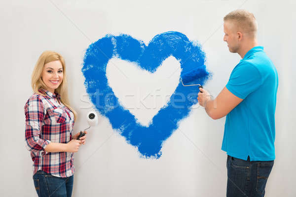 Couple Painting Heart On Wall Stock photo © AndreyPopov