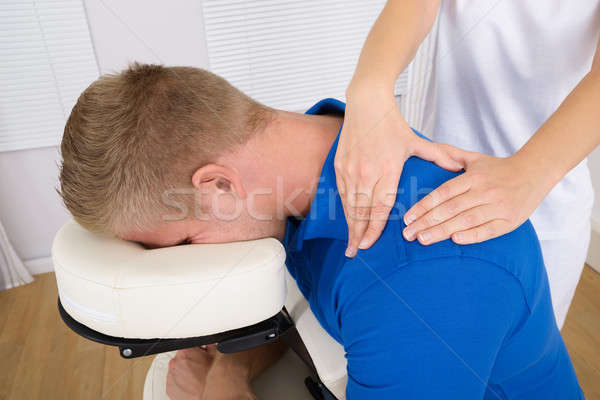 Stock photo: Physiotherapist Massaging Man's Shoulder