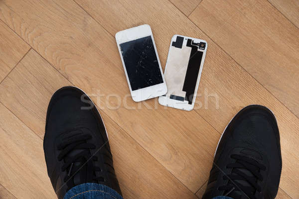 Person Standing Near Broken Cellphone Stock photo © AndreyPopov