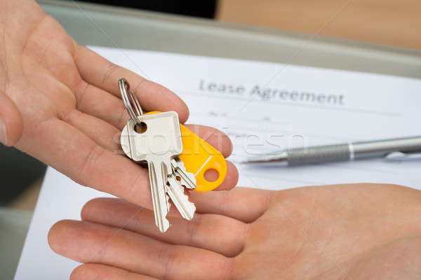 Close-up Of A Person Giving Key To Man Stock photo © AndreyPopov