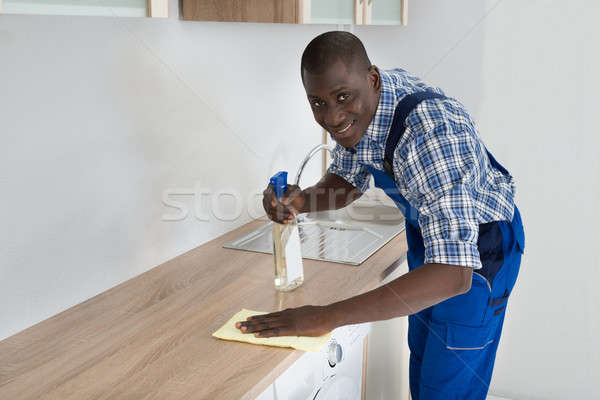 Janitor Cleaning Kitchen Worktop Stock photo © AndreyPopov