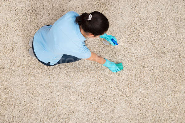 Young Woman Cleaning Carpet Stock photo © AndreyPopov