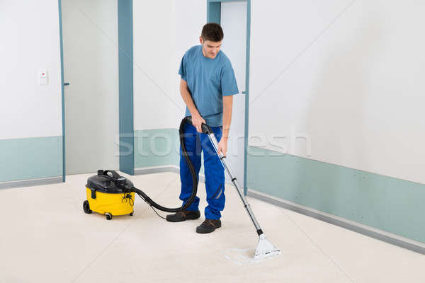 Male Cleaner Vacuuming Floor Stock photo © AndreyPopov