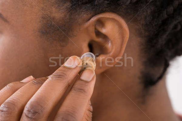 Női kéz hallókészülék fül közelkép nő Stock fotó © AndreyPopov