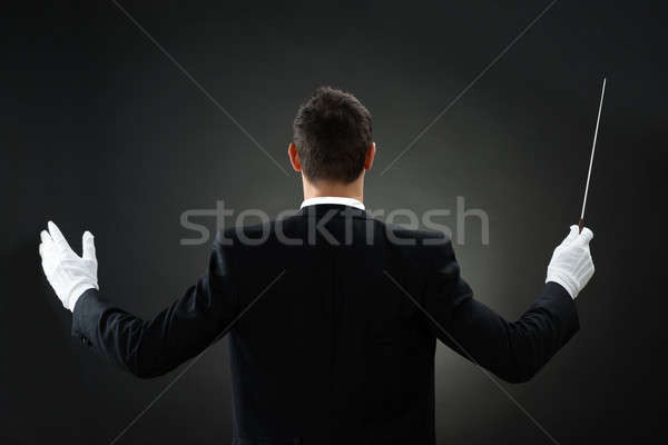 Rear View Of Music Conductor Holding Baton Stock photo © AndreyPopov