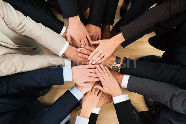 Business Team Stacking Hands On Table Stock photo © AndreyPopov