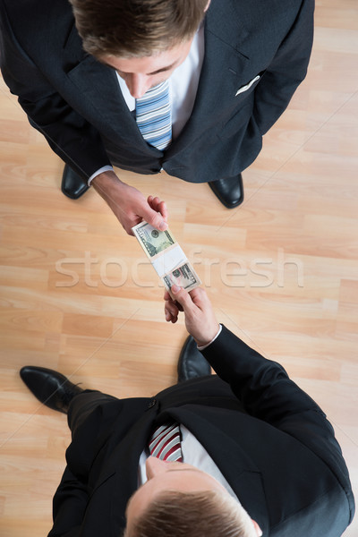 Businessman Bribing Colleague In Office Stock photo © AndreyPopov