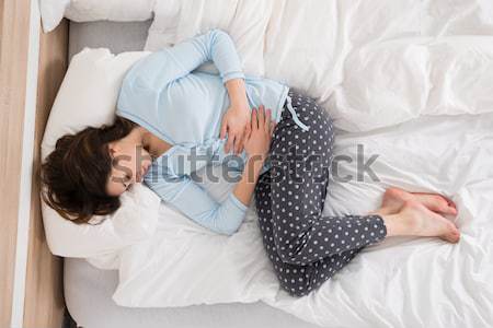 Stock photo: Sad Couple Lying On Bed