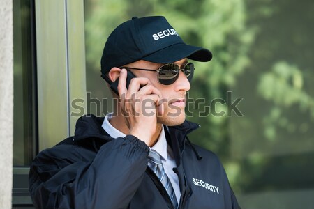 Security Guard Listening To Earpiece Stock photo © AndreyPopov