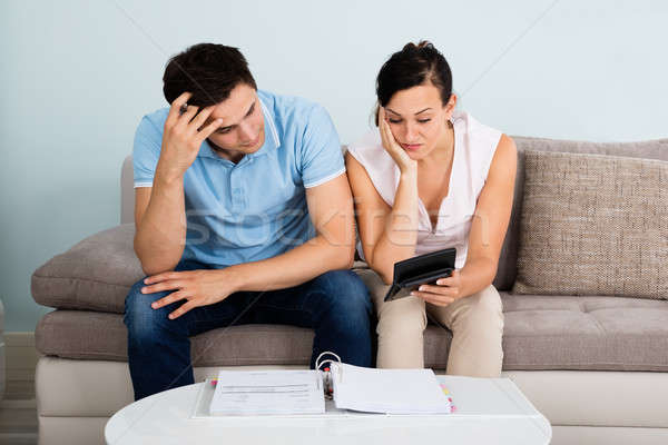 Unhappy Couple Calculating Bills Stock photo © AndreyPopov