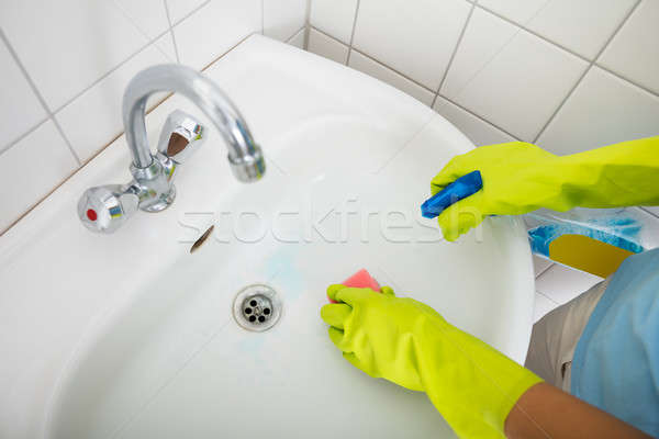 Person Cleaning The Basin Of The Bathroom Stock photo © AndreyPopov