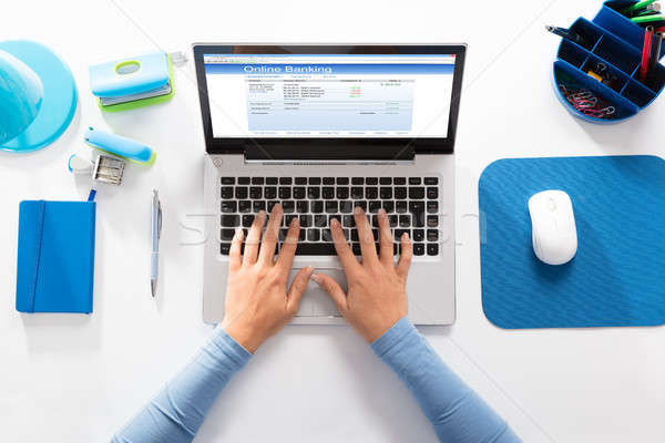 Woman Doing Online Banking On Laptop Stock photo © AndreyPopov