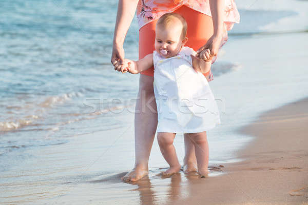 Mother With Baby Daughter Walking Near The Coast At Beach Stock photo © AndreyPopov