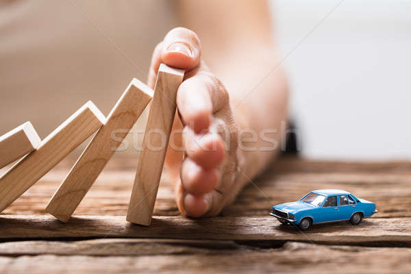 Person Stopping Falling Wooden Blocks Stock photo © AndreyPopov