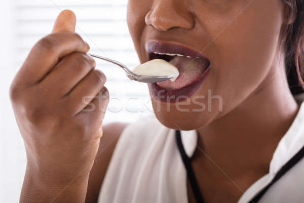 Woman Eating Yogurt Stock photo © AndreyPopov