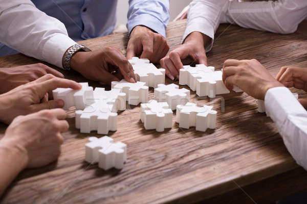 Stock photo: Businesspeople Solving Jigsaw Puzzle Together