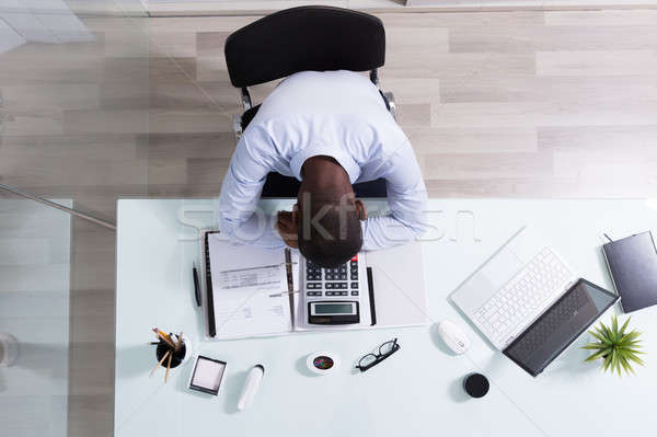 Overhead View Of A Businessman Sleeping At Workplace Stock photo © AndreyPopov