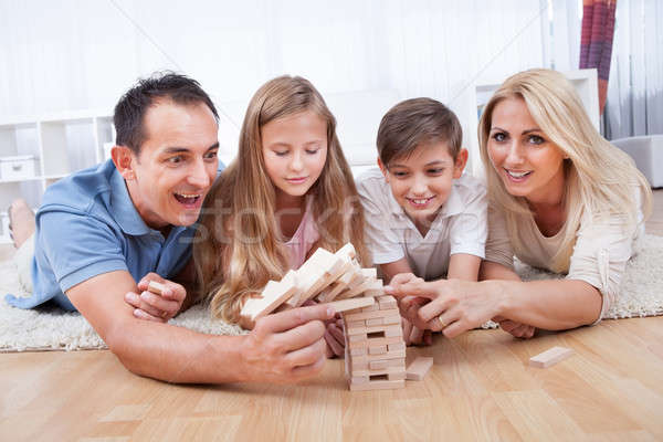 Happy Family Collapsing The Wooden Blocks Stock photo © AndreyPopov