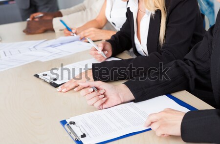 Business executives taking notes during a meeting Stock photo © AndreyPopov