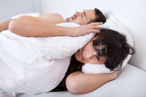 Young woman and her snoring boyfriend Stock photo © AndreyPopov