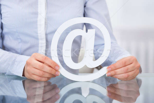 Businessperson Holding Email Sign At Workplace Stock photo © AndreyPopov