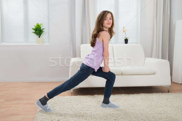 Girl Exercising In Living Room Stock photo © AndreyPopov