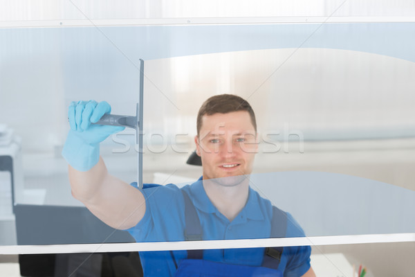 Worker Cleaning Glass Window With Squeegee Stock photo © AndreyPopov