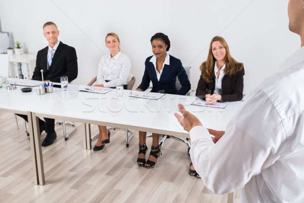 Businessperson Talking To Colleague Stock photo © AndreyPopov