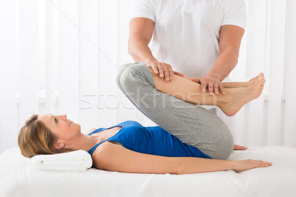 Man Giving Massage To Woman Stock photo © AndreyPopov