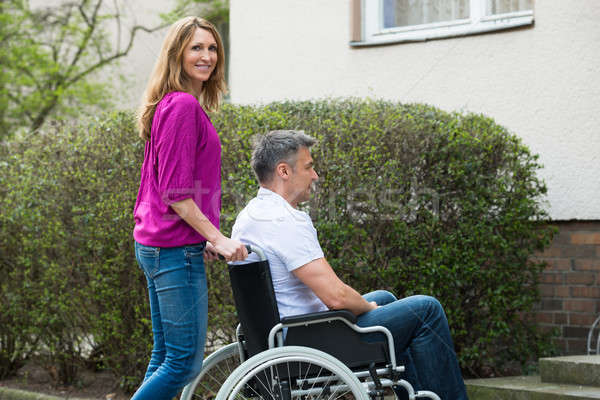 Happy Woman With Her Disabled Husband Stock photo © AndreyPopov