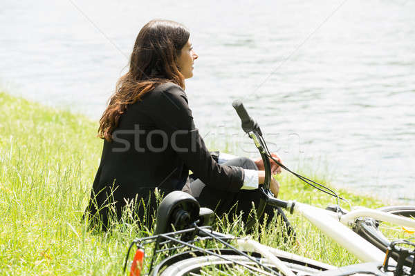 Businesswoman Sitting By Lakeside Stock photo © AndreyPopov