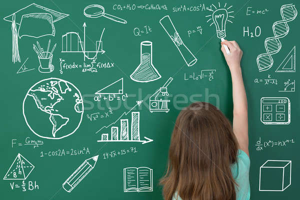 Girl Drawing On Green Chalkboard Stock photo © AndreyPopov