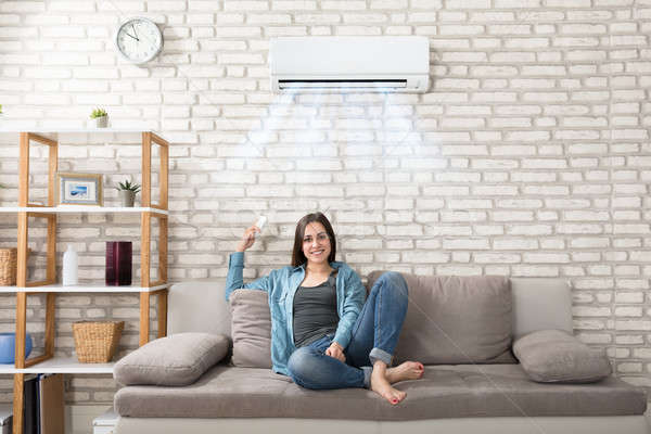 Woman Relaxing Under The Air Conditioner Stock photo © AndreyPopov