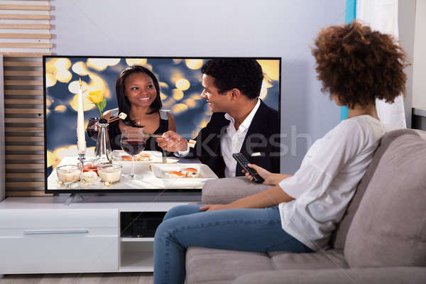 Woman Watching Television At Home Stock photo © AndreyPopov