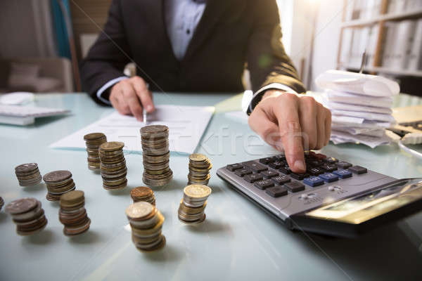 Close-up Of Stacked Coins On Desk Stock photo © AndreyPopov