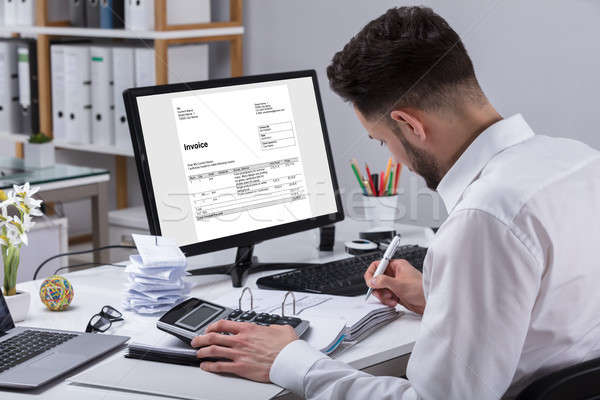 Businessman Calculating Invoice Stock photo © AndreyPopov