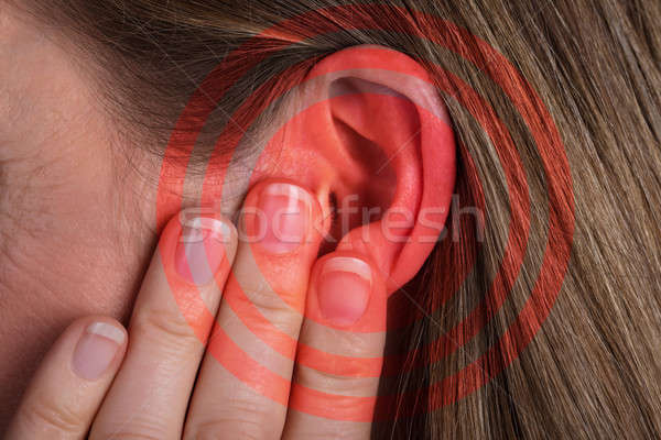Red Circle Pattern On Woman's Ear Stock photo © AndreyPopov