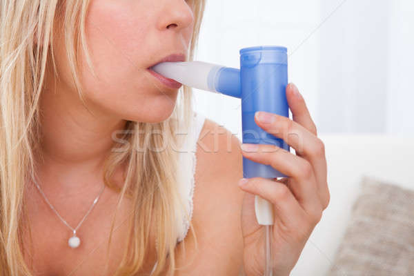 Woman with asthma inhaler Stock photo © AndreyPopov