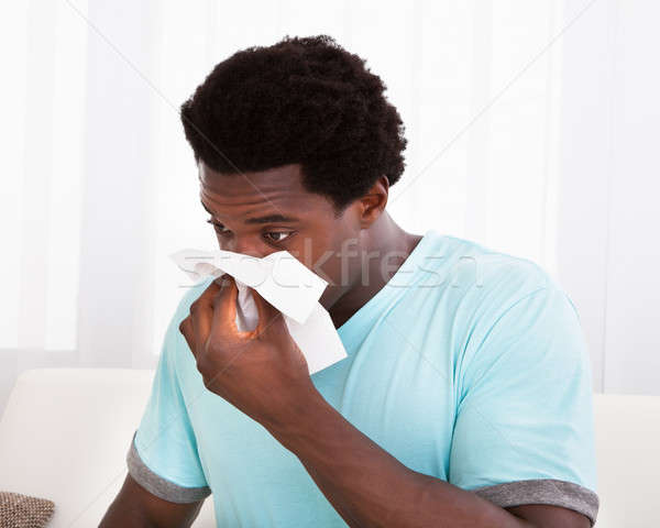 Giovane soffia il naso tessuto african freddo Foto d'archivio © AndreyPopov