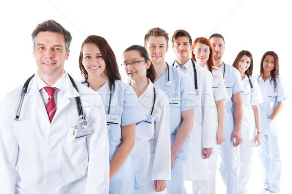 Long line of smiling doctors and nurses Stock photo © AndreyPopov