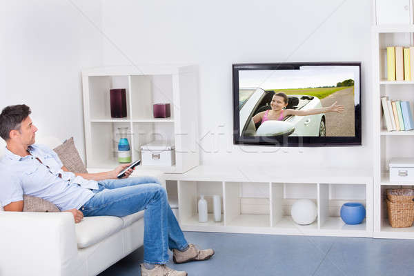 男子 看電視 成熟的男人 坐在 榻 電視 商業照片 © AndreyPopov